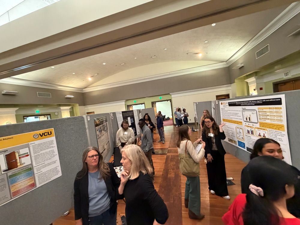People walking around viewing posters at grad symposium 2026