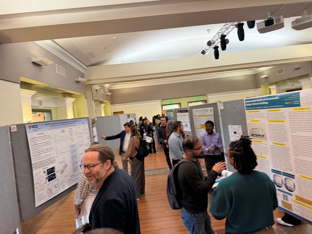 People walking around viewing posters at grad symposium 2026